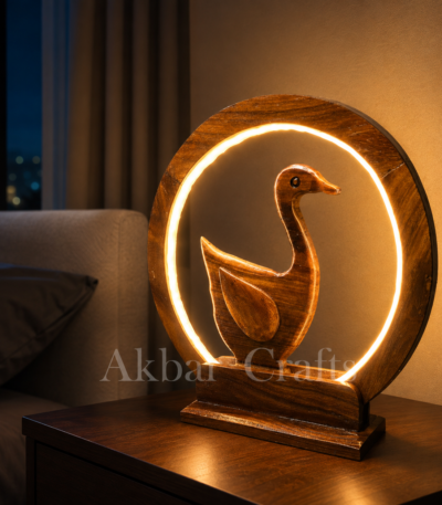 Handcrafted wooden Swan LED ring lamp glowing on a bedside table